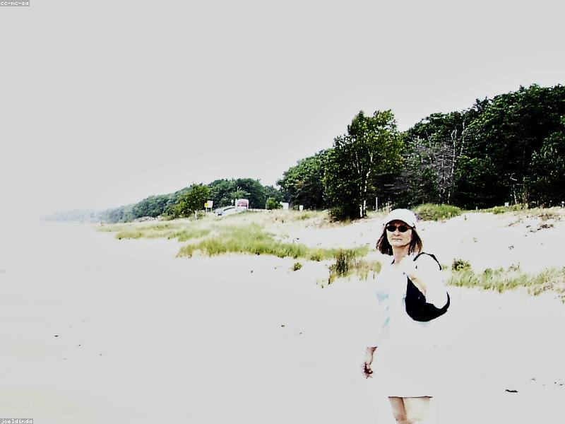 Happy family walking on a sunny beach during vacation